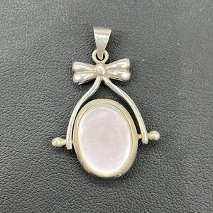 Sterling silver reversible black and white pendant with sweet bow